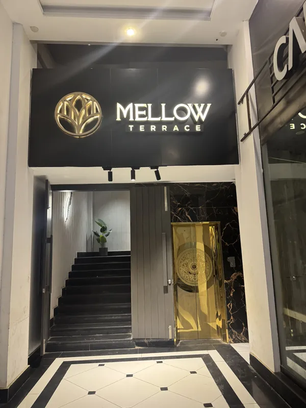Mellow Terrace entrance with the gold lotus sign and stairs